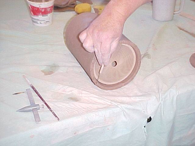 Scoring the bottom of the jug wall
